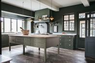 <p>Olive green tones and mossy grays reference the English landscape outside the windows of this Shropshire kitchen renovated by design firm <a href="https://www.plainenglishdesign.co.uk/" rel="nofollow noopener" target="_blank" data-ylk="slk:Plain English" class="link ">Plain English</a>. The prep island at the center of the cook space helps connect the room to its origins as an 1890 farmhouse with freestanding furniture. </p>