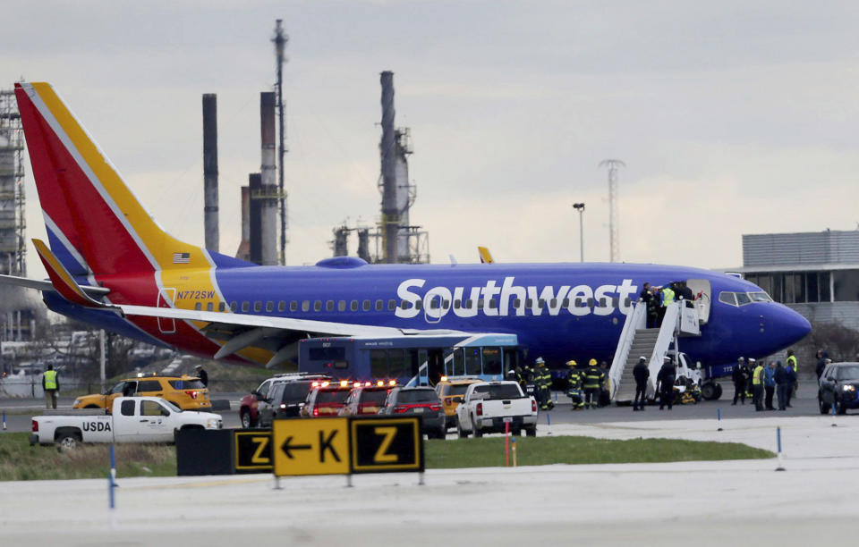 <em>The Southwest Airlines plane sits on the runway at the Philadelphia International Airport after it made an emergency landing (AP)</em>