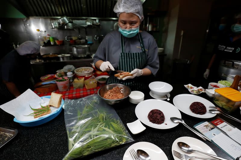 A chef prepares a pork sandwich with a marijuana leaf at Abhaibhubejhr hospital canteen which adds cannabis infused dishes to its menu in Thailand