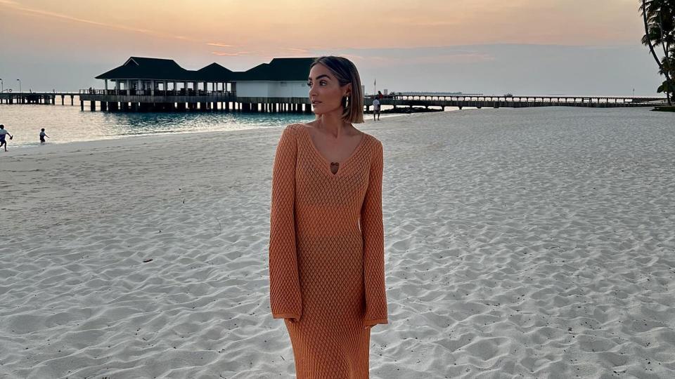 woman wearing orange beach dress 