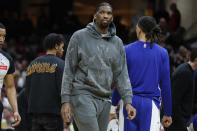 Injured Philadelphia 76ers center Joel Embiid stands during a timeout in the second half of the team's NBA basketball game against the Cleveland Cavaliers, Friday, March 29, 2024, in Cleveland. (AP Photo/Ron Schwane)