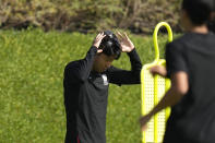 South Korea's Son Heung-min adjusts a mask during the South Korea's official training on the eve of the group H World Cup soccer match between South Korea and Ghana, at the Al Egla Training Site 5 in Doha, Qatar, Sunday, Nov. 27, 2022. (AP Photo/Lee Jin-man)