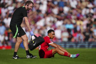 Liverpool's Trent Alexander-Arnold sits on the pitch injured during the English Premier League soccer match between Liverpool and Aston Villa at Anfield stadium in Liverpool, Sunday, Sept. 3, 2023. (AP Photo/Jon Super)