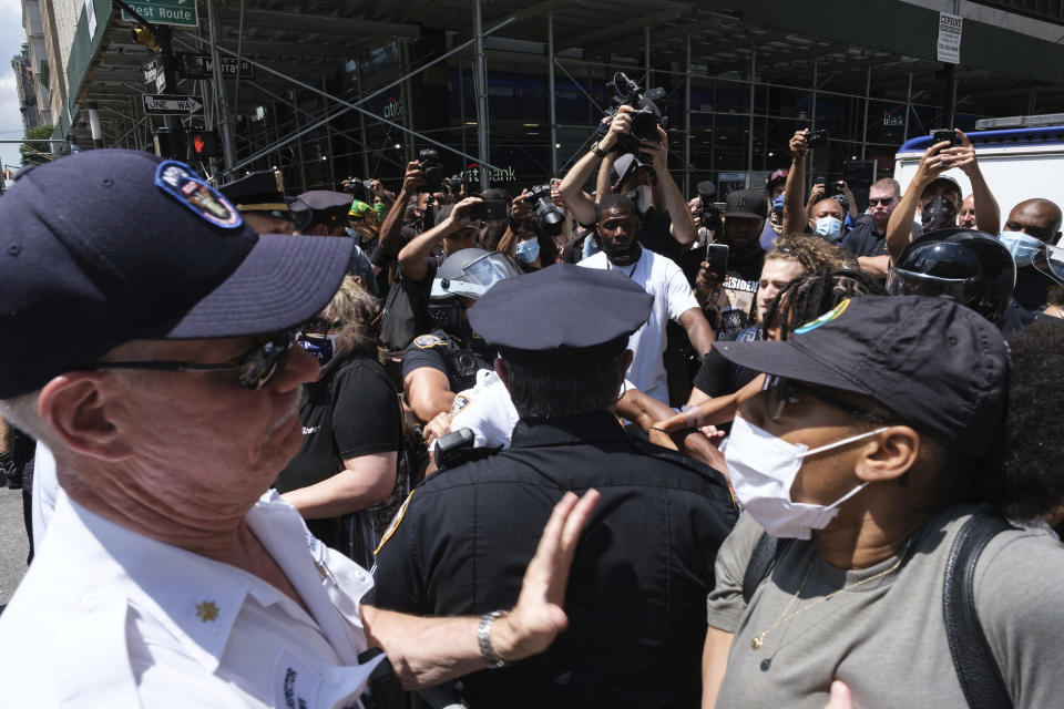 Black Lives Matter protesters and NYPD officers have a confrontation near City Hall Park, Wednesday, July 15, 2020, in New York. (AP Photo/Yuki Iwamura)