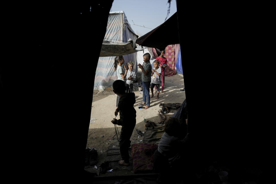 Children play near their family's tent in Deir al Balah, on Saturday, April 20, 2024. Since the war erupted Oct 7, all of Gaza's schools have closed, and aid groups are scrambling to keep children off the streets and their minds focused on something other than the war. (AP Photo/Abdel Kareen Hana)