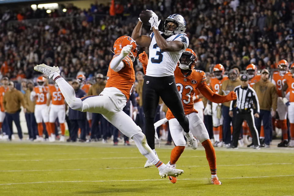 Carolina Panthers running back Raheem Blackshear (3) catches a pass between Chicago Bears cornerbacks Kyler Gordon, left, and Jaylon Johnson during the second half of an NFL football game Thursday, Nov. 9, 2023, in Chicago. (AP Photo/Charles Rex Arbogast)