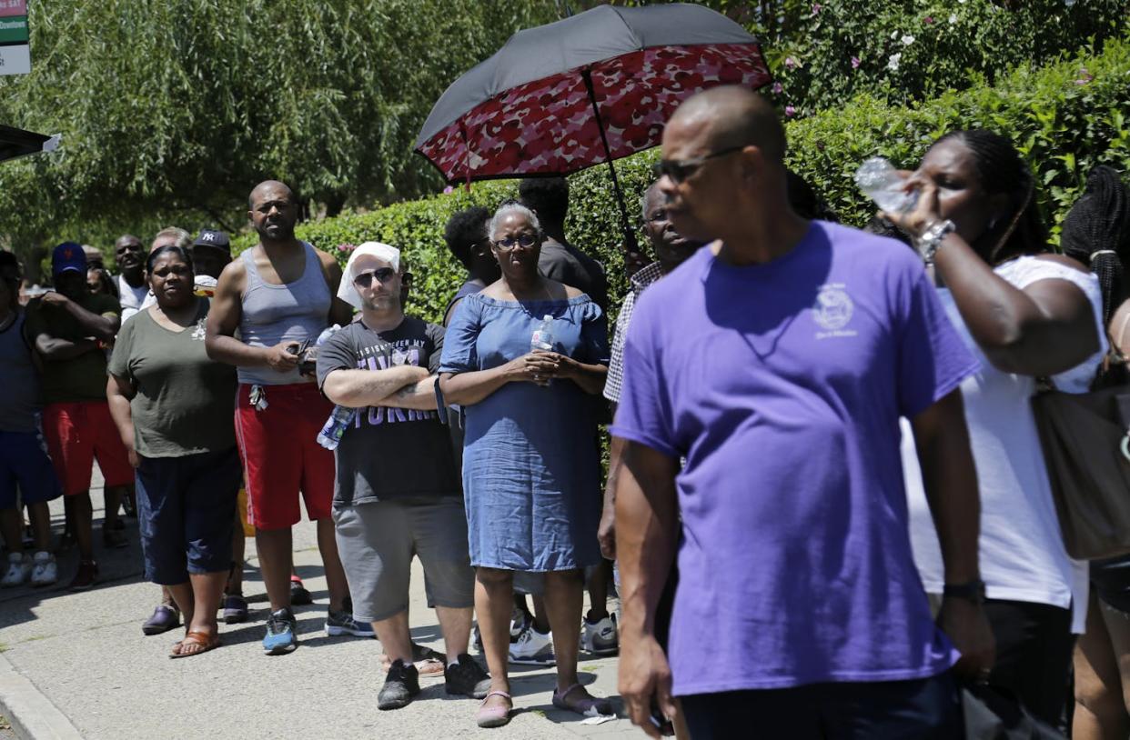 People line up for ice provided by a utility company during a 2019 power outage in Brooklyn. <a href="https://newsroom.ap.org/detail/HotWeatherNYC/4ce2882e948d4a34bbcaaefb3f8e2d90/photo" rel="nofollow noopener" target="_blank" data-ylk="slk:AP Photo/Seth Wenig;elm:context_link;itc:0;sec:content-canvas" class="link ">AP Photo/Seth Wenig</a>