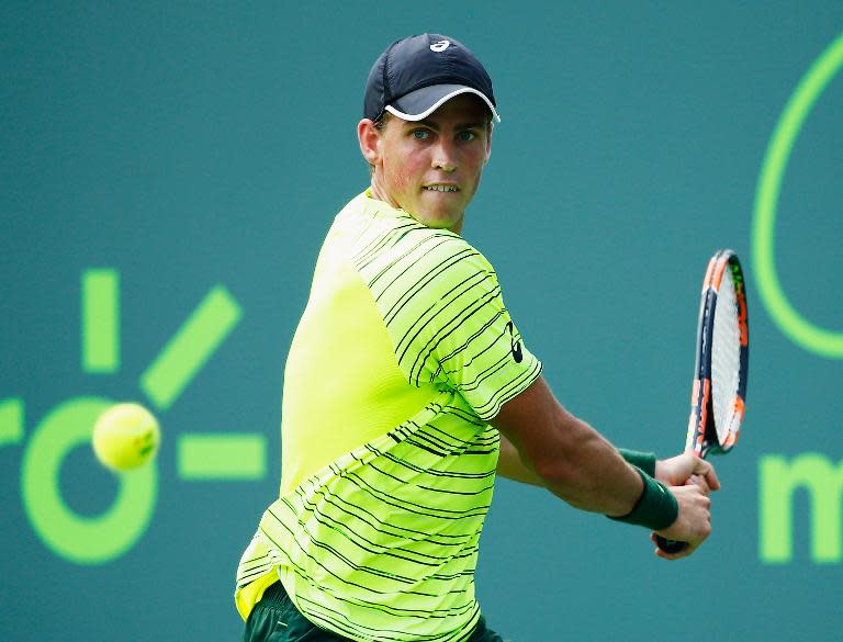 Vasek Pospisil of Canada returns the ball to Juan Martin Del Potro of Argentina during their match at Miami Open, in Key Biscayne, Florida, on March 26, 2015