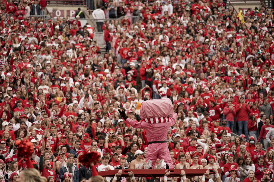 Bucky Badger, Wisconsin's mascot, celebrates with the fans after a Wisconsin touchdown against Iowa during the first half of an NCAA college football game Saturday, Oct. 30, 2021, in Madison, Wis. Wisconsin upset Iowa 27-7. (AP Photo/Andy Manis)