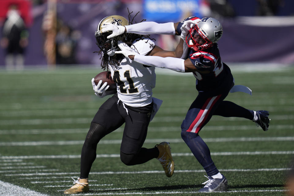 New Orleans Saints running back Alvin Kamara, left, is pushed out of bounds by New England Patriots defensive back J.C. Jackson, right, during the first half of an NFL football game, Sunday, Oct. 8, 2023, in Foxborough, Mass. (AP Photo/Charles Krupa)