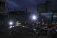 People walk pass the Petion-Ville market during a general strike in Port-au-Prince, Monday, Oct. 18, 2021. Workers angry about the nation's lack of security went on strike in protest two days after 17 members of a US-based missionary group were abducted by a violent gang. (AP Photo/Matias Delacroix)