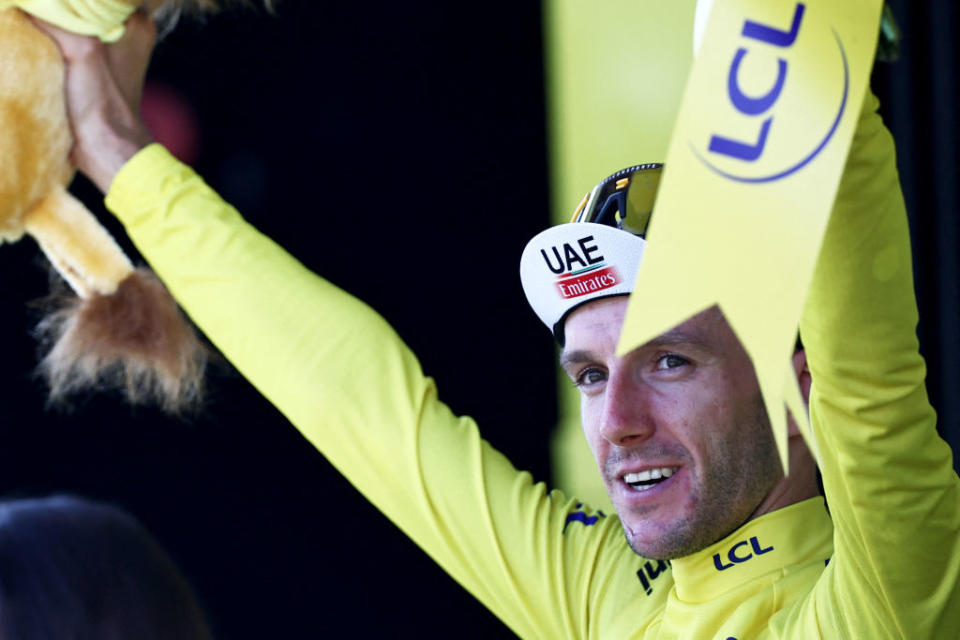 UAE Team Emirates British rider Adam Yates celebrates on the podium with the overall leaders yellow jersey after the 3rd stage of the 110th edition of the Tour de France cycling race 1935 km between AmorebietaEtxano in Northern Spain and Bayonne in southwestern France on July 3 2023 Photo by AnneChristine POUJOULAT  AFP Photo by ANNECHRISTINE POUJOULATAFP via Getty Images