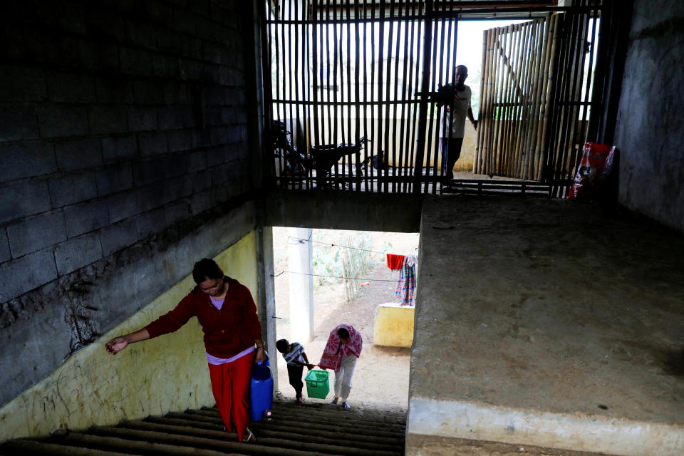 Marie Dalama Acampong, 37, and her daughter Shieka, 15, carry containers filled with water at the school-turned-evacuation center in Mipaga, Marawi City, Lanao del Sur province, Philippines. (Photo: Eloisa Lopez/Reuters)