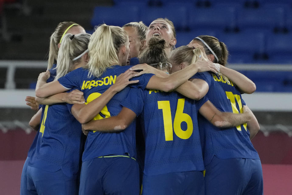 Sweden players celebrate after Fridolina Rolfo scoring her side's opening goal against Australia during a women's semifinal soccer match at the 2020 Summer Olympics, Monday, Aug. 2, 2021, in Yokohama, Japan. (AP Photo/Kiichiro Sato)