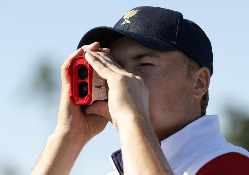 FILE - Jordan Spieth looks through a range finder following his four ball match at the Presidents Cup golf tournament at the Jack Nicklaus Golf Club Korea, in Incheon, South Korea, in this Friday, Oct. 9, 2015, file photo. Players will be allowed to use the measuring devices at the PGA Championship next week, the first time that's been allowed at a major. (AP Photo/Lee Jin-man, File)