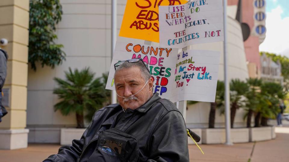 Former Oklahoma Avenue Safe Parking Site resident Dave Richford holds signs during a demonstration Tuesday afternoon, Jan. 23, 2024, at the Katcho Achadjian Government Center. The San Luis Obispo County chapter of the California Homeless Union filed a lawsuit against the county and the Community Action Partnership of San Luis Obispo related to the operation of the safe parking site and treatment of its residents. John Lynch/jlynch@thetribunenews.com