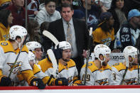 Nashville Predators head coach Peter Laviolette, back, directs his players in the second period of an NHL hockey game against the Colorado Avalanche Monday, Jan. 21, 2019, in Denver. (AP Photo/David Zalubowski)