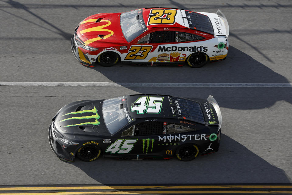 TALLADEGA, ALABAMA - APRIL 24: Kurt Busch, driver of the #45 Monster Energy Toyota, and Bubba Wallace, driver of the #23 McDonald's Toyota, race during the NASCAR Cup Series GEICO 500 at Talladega Superspeedway on April 24, 2022 in Talladega, Alabama. (Photo by Sean Gardner/Getty Images)