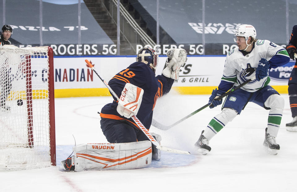 Edmonton Oilers goalie Mikko Koskinen (19) is scored against by Vancouver Canucks' Brock Boeser (6) during third-period NHL hockey game action in Edmonton, Alberta, Saturday, May 15, 2021. (Jason Franson/The Canadian Press via AP)