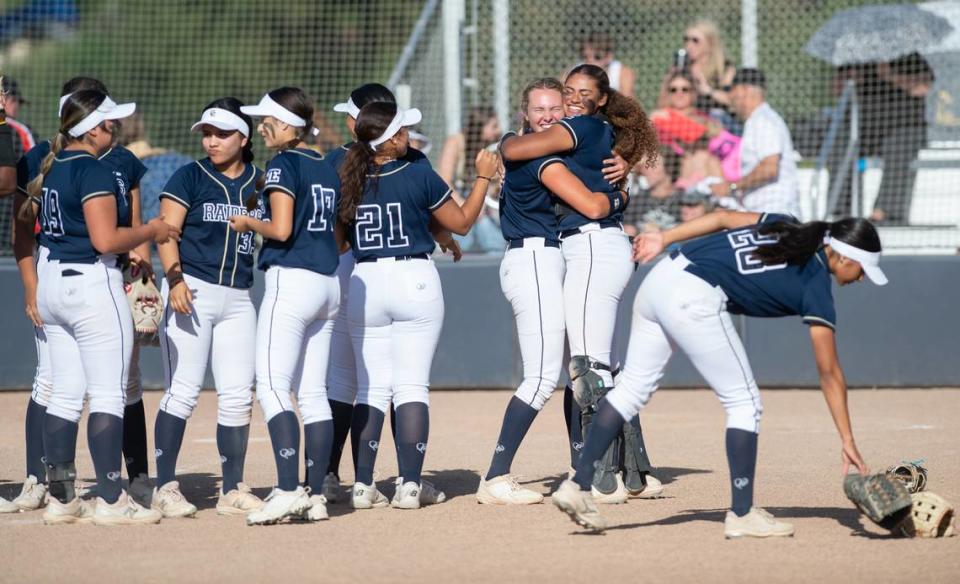 Central Catholic pitcher Randi Roelling and catcher Madison Harrison hug, right, as they celebrate a 6-0 shutout of Oakdale with their teammates after the Valley Oak League game at Central Catholic High School in Modesto, Calif., Tuesday, April 25, 2023.