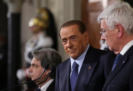 Italy's former Prime Minister Silvio Berlusconi (C) looks on as he leaves at the end of his consultations with Italian President Sergio Mattarella at the Quirinale Palace in Rome, Italy December 10, 2016. REUTERS/Alessandro Bianchi