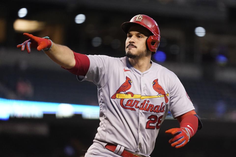 St. Louis Cardinals' Nolan Arenado points to hecklers in the stands after his home run against the Arizona Diamondbacks during the third inning of a baseball game Friday, May 28, 2021, in Phoenix. (AP Photo/Ross D. Franklin)