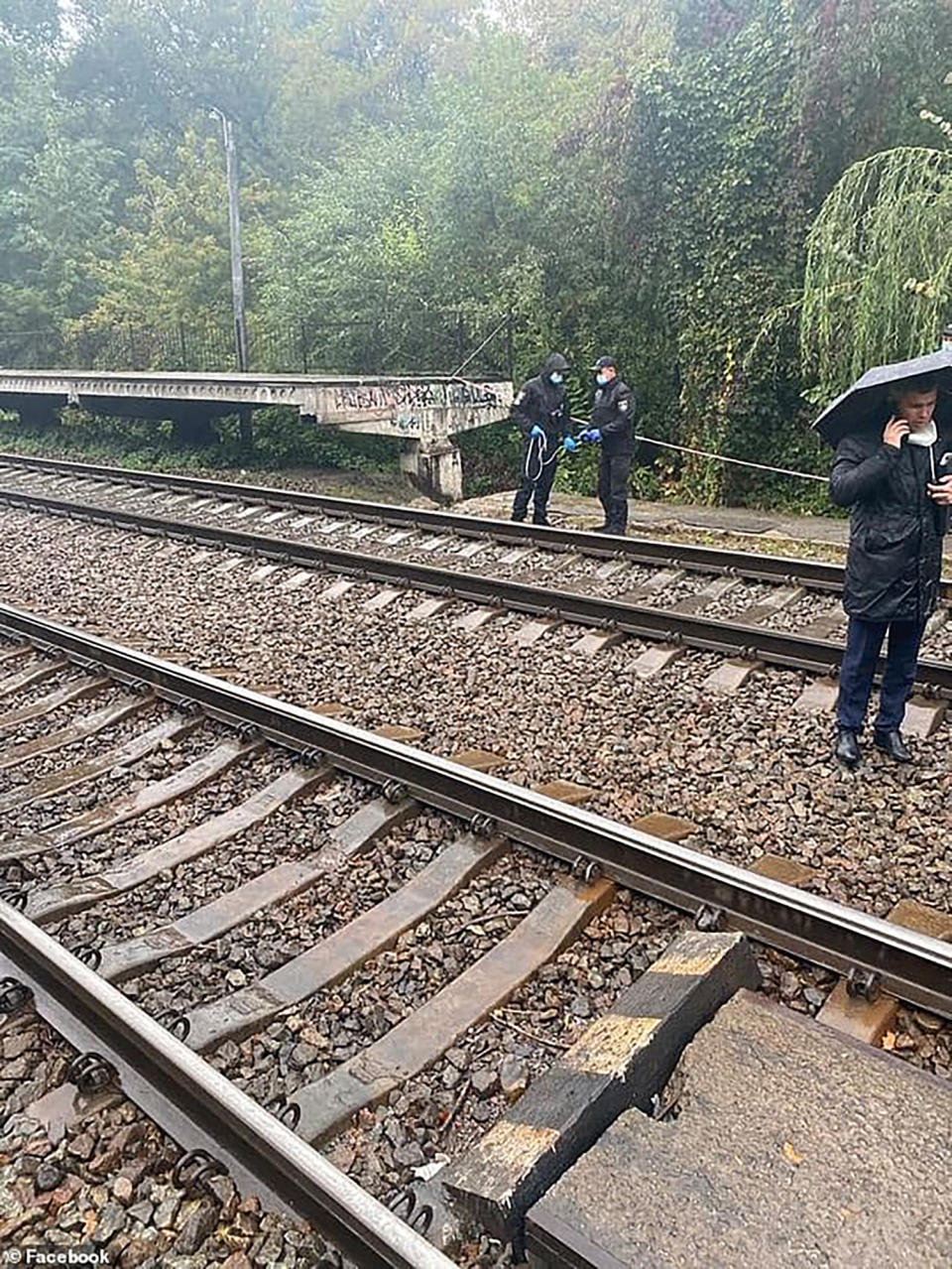 In this photo released by Ministry of Internal Affairs of Ukraine on Wednesday, Sept. 30, 2020, investigators work at the scene of an accident in Kyiv, Ukraine. Police in Ukraine are investigating the death of an American woman who worked for the United States Embassy in Kyiv. The woman was found unconscious with a head injury near the railway tracks in a park not far from the embassy on Wednesday, according to a police statement. She died in a hospital later in the day. (Ministry of Internal Affairs of Ukraine via AP)