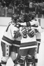 FILE - In this Feb. 22, 1980, file photo, U.S. player Michael Eruzione, left, is congratulated by teammates James Craig, John O'Callahan and David Silk after scoring the teams fourth goal in a 4-3 win over the Soviet Union in a medal round match at the 1980 Winter Olympics in Lake Placid, N.Y. (AP Photo/File)