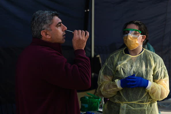 A man places as swab in his nose as he is tested at a pop-up testing facility, during a COVID-19 testing blitz in the suburb of Broadmeadows in Melbourne, Australia. 