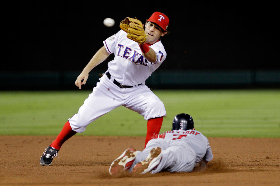 ARLINGTON, TX - OCTOBER 24: Matt Holliday #7 of the St. Louis Cardinals slides into second base safely ahead of the tag by Ian Kinsler #5 of the Texas Rangers after a wild pitch in the second inning during Game Five of the MLB World Series at Rangers Ballpark in Arlington on October 24, 2011 in Arlington, Texas. (Photo by Rob Carr/Getty Images)