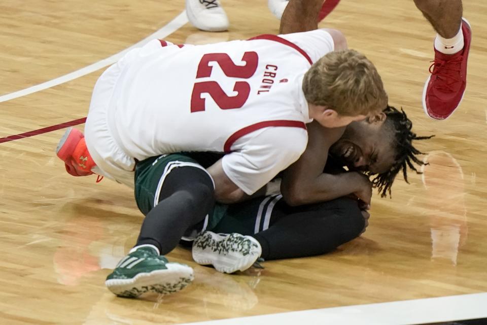 Wisconsin's Steven Crowl and Wisconsin-Green Bay's PJ Pipes go after a loose ball during the second half of an NCAA college basketball game Tuesday, Dec. 1, 2020, in Madison, Wis. (AP Photo/Morry Gash)
