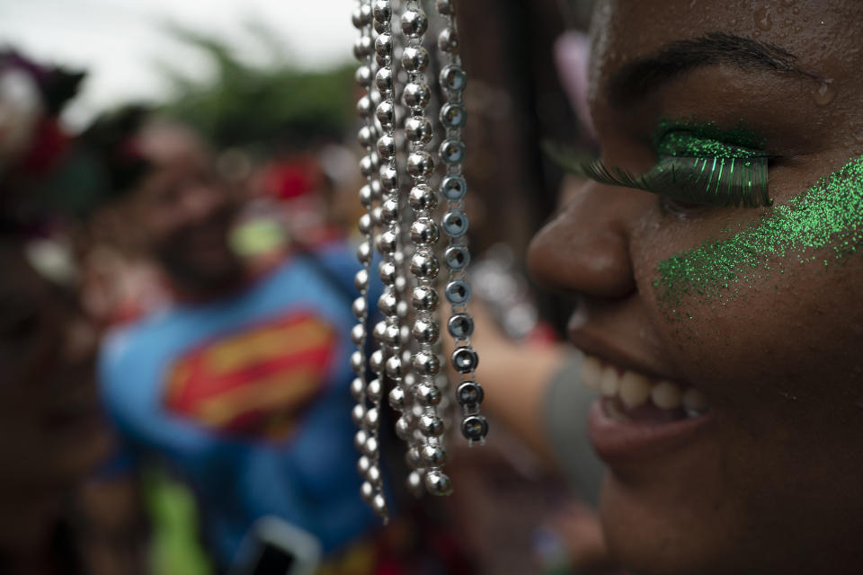 A reveler in a costume enjoys the "Ceu na Terra" or Heaven on Earth street party in Rio de Janeiro, Brazil, Saturday, Feb. 22, 2020. From very early in the morning revelers take the streets of the bohemian neighborhood Santa Teresa for one of the many block parties during the Carnival celebrations in the city. (AP Photo/Leo Correa)