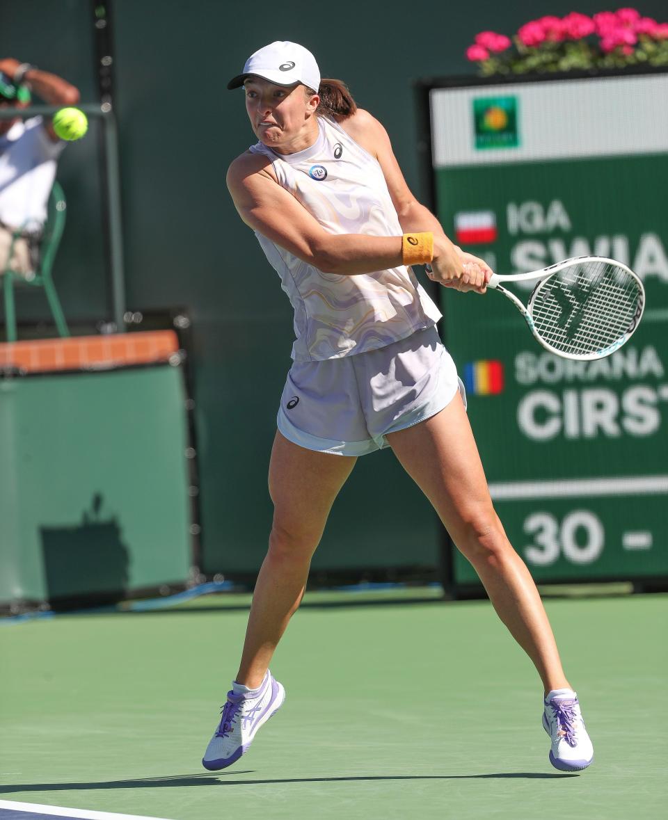 Iga Swiatek hits a shot during her quarterfinal victory over Sorona Cirstea during the BNP Paribas Open at the Indian Wells Tennis Garden in Indian Wells, Calif., March 16, 2023.