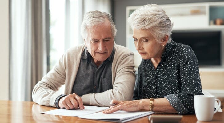 A couple looks over their estate plan. An AB trust can help minimize the estate taxes owed on the transfer of assets.