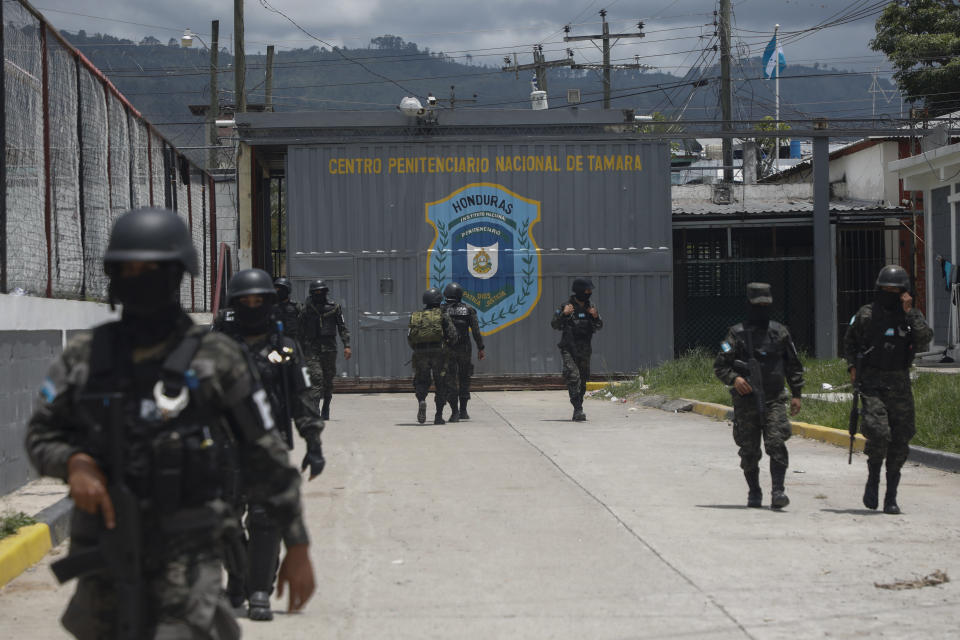 Military police guard the entrance to the National Penitentiary Center in Tamara, on the outskirts of Tegucigalpa, Honduras, Tuesday, June 26, 2023. Honduran President Xiomara Castro has put the military police in charge of the country's poorly-run prisons as the Central American country adopts El Salvador-style tactics in an anti-gang crackdown on prison inmates. (AP Photo/Elmer Martinez)