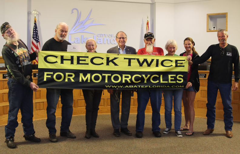 Members of ABATE of Florida's Polk County Chapter stand with Lakeland Mayor Bill Mutz after receiving a proclamation recognizing May as Motorcycle Safety Awareness Month