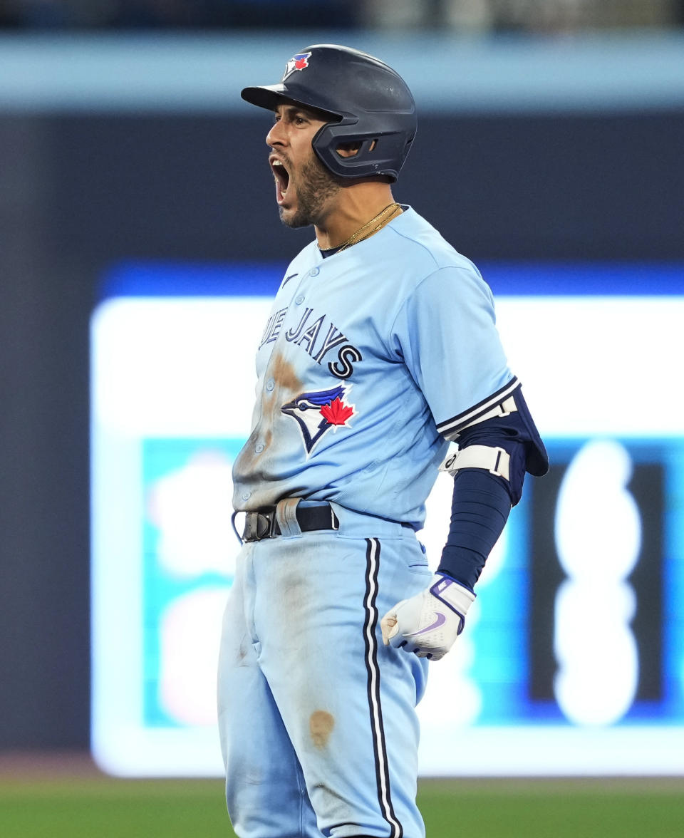 Toronto Blue Jays' George Springer celebrates a double against the Minnesota Twins during the ninth inning of a baseball game Friday, June 9, 2023, in Toronto. (Mark Blinch/The Canadian Press via AP)