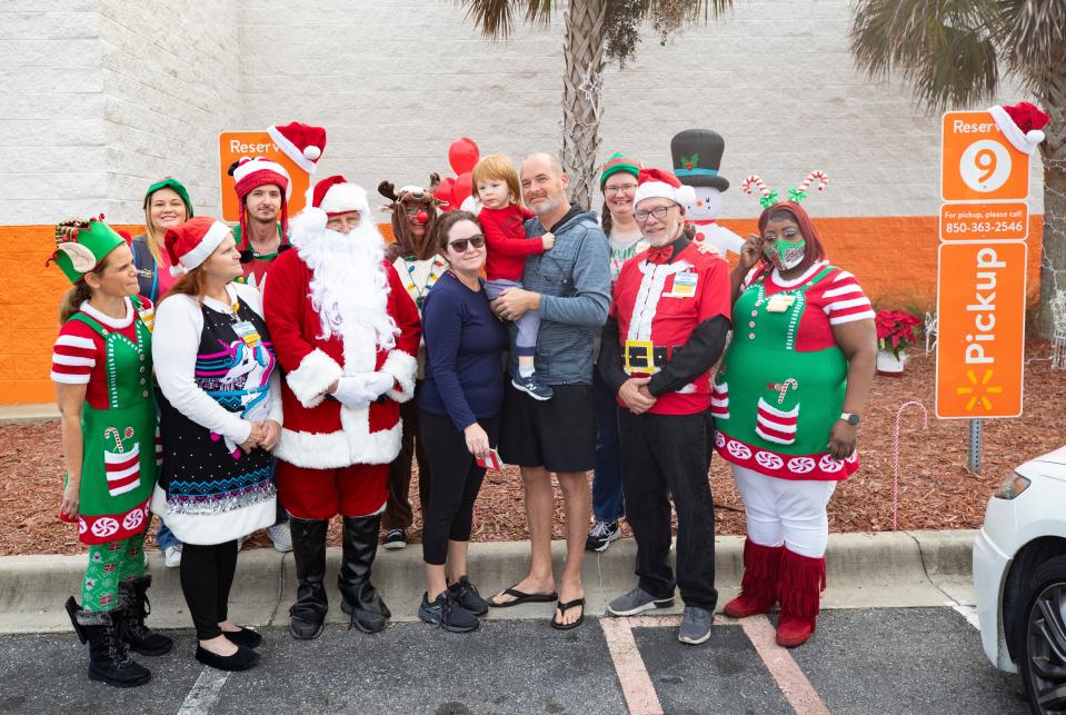 The Walmart store on Panama City Beach Parkway treated one of their pick up order customers Friday with a Christmas surprise. Alan and Anais Bearden, and their son Bennett, were greeted by Santa and his elves when they arrived to get their order. Walmart gave them their order for free and included a one year Walmart+ membership in the surprise. In the photo the Bearden family poses for a photo with the Walmart elves and Santa.