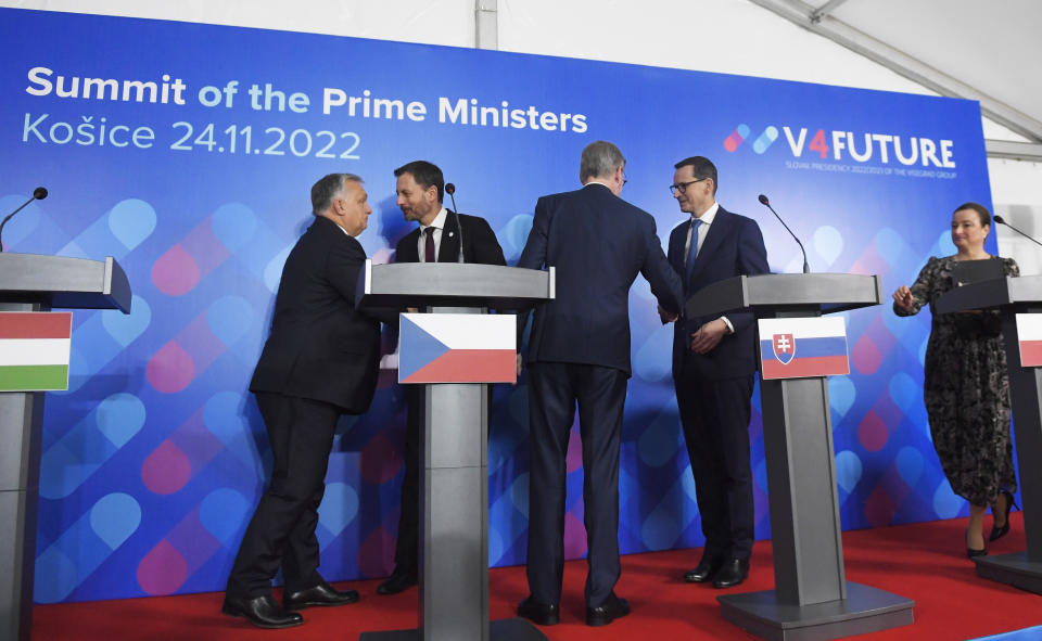 From left, Prime Ministers Viktor Orban of Hungary, Eduard Heger of Slovakia, Petr Fiala of the Czech Republic and Mateusz Morawiecki of Poland shake hands during a joint press conference after the summit of Visegrad Group (V4) prime ministers in Kosice, Slovakia, Thursday Nov. 24, 2022. (Frantisek Ivan/TASR via AP)