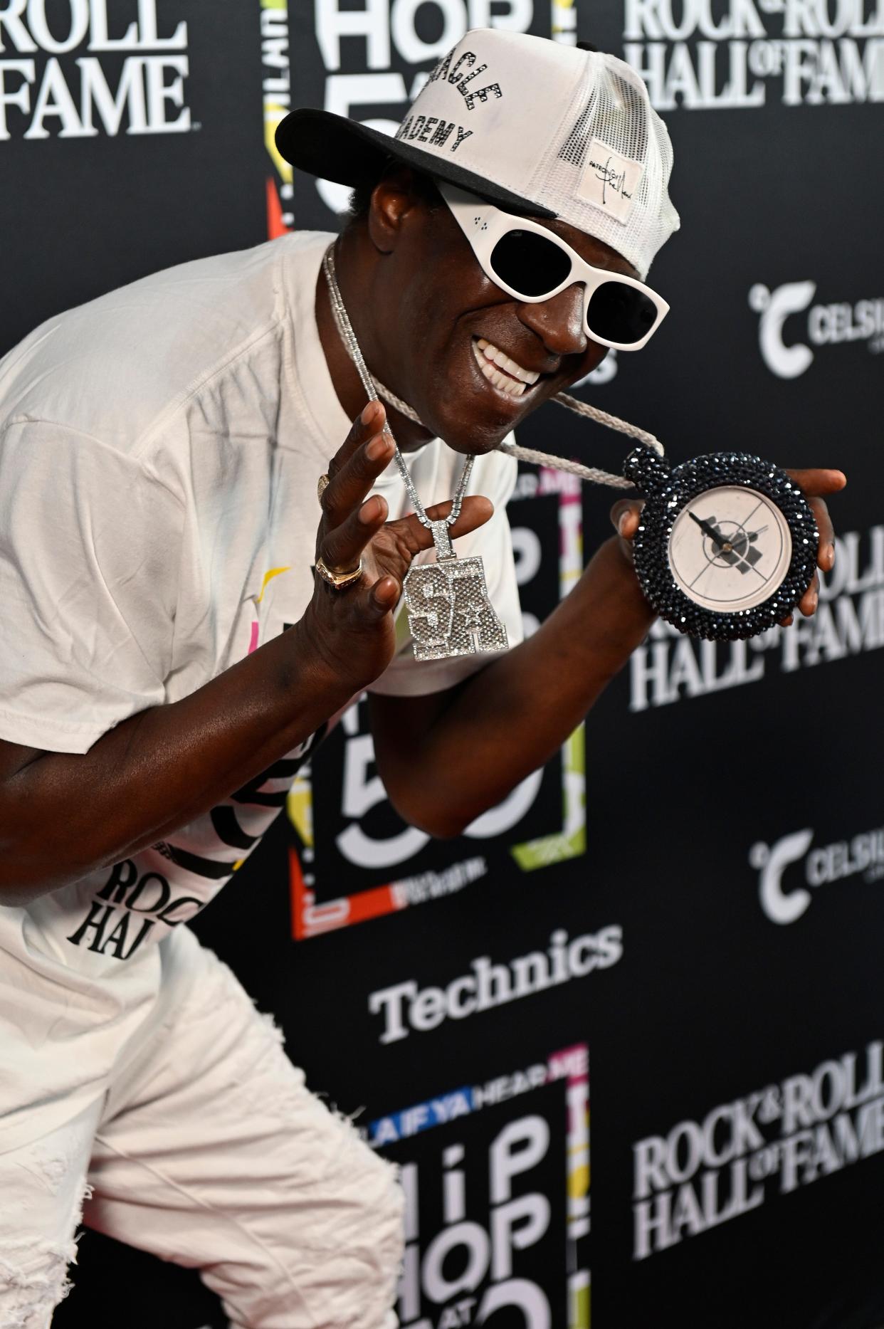 Flavor Flav shows off custom necklaces while attending a Hip-Hop at 50 event in Cleveland, Ohio.