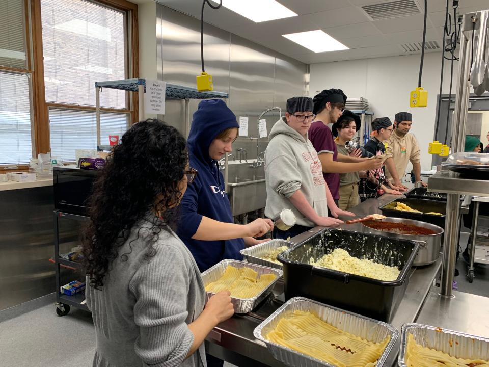 East High School culinary students work in an assembly line making lasagnas for Eats for East at East High School on November 10, 2022 in Green Bay, Wisconsin.