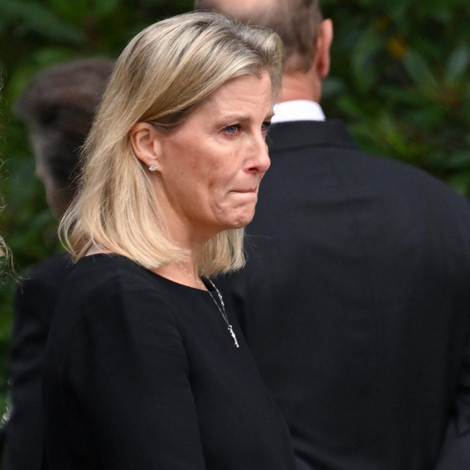 The Countess looked tearful as she inspected the flowers left by well-wishers at Balmoral - Karwai Tang