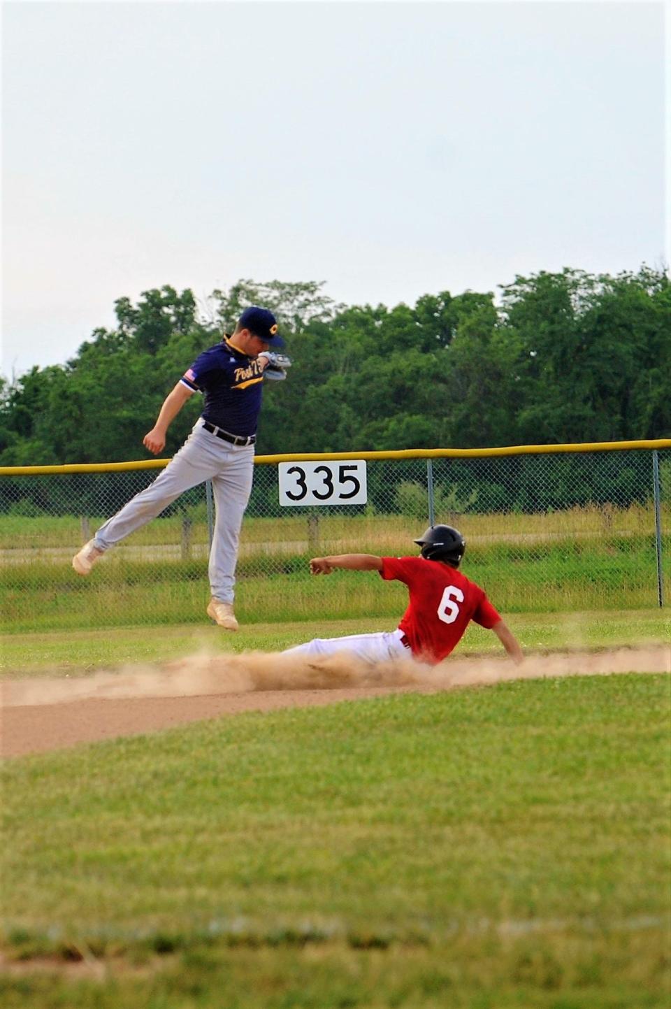 Post 757's David Magill making a leaping catch hoping to catch a Hillsboro runner stealing.