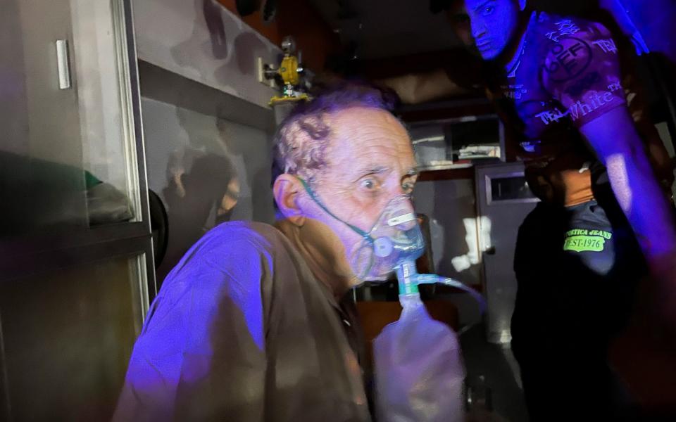 A patient suffering from the coronavirus is prepared for evacuation in an ambulance  - Reuters