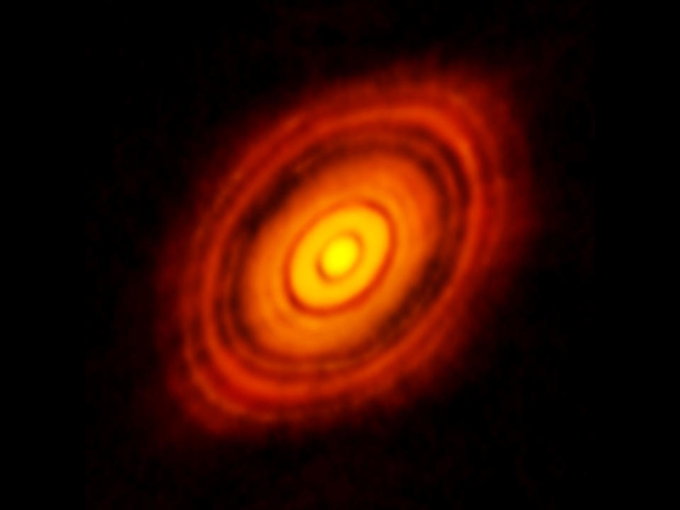 photo of faint yellow and orange concentric rings in deep space