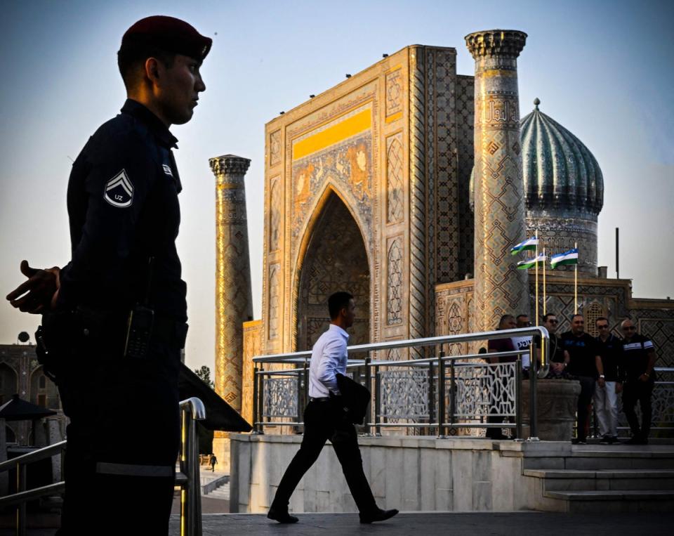 A police officer stands guard in Registan Square in downtown Samarkand (AFP via Getty)