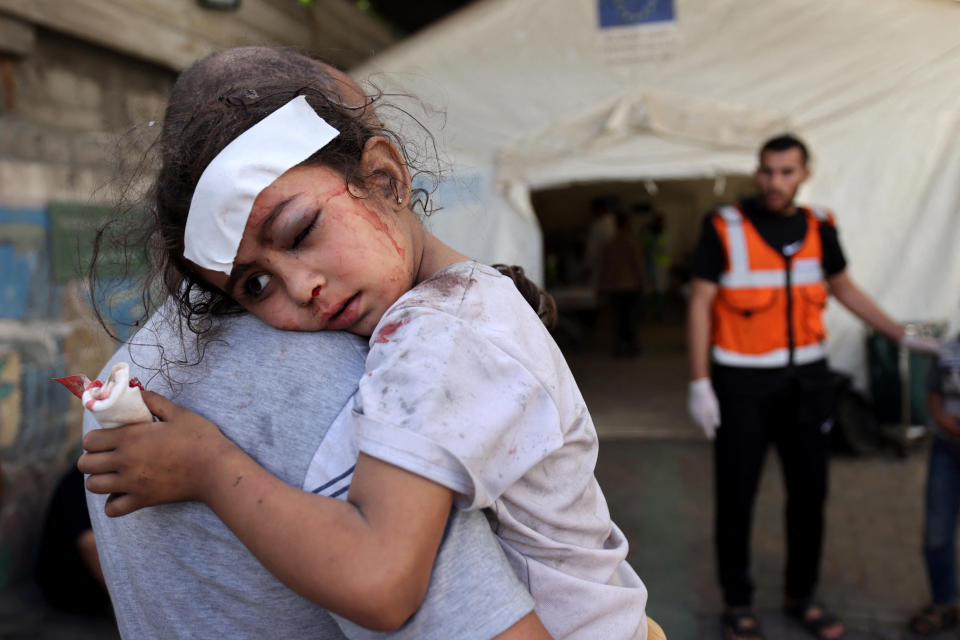 <sub>A man carries a wounded girl after an Israeli airstrike on Rafah on October 17, Mohammed Abed, AFP via Getty Images</sub>