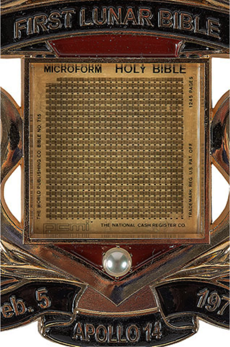 In this undated photo provided by the Museum of the Bible, a photo of the Lunar Bible on display at the museum. The museum has quietly replaced an artifact purported to be one of a handful of miniature Bibles that a NASA astronaut carried to the moon in 1971 after an expert questioned its authenticity. (Museum of the Bible Collection via AP)