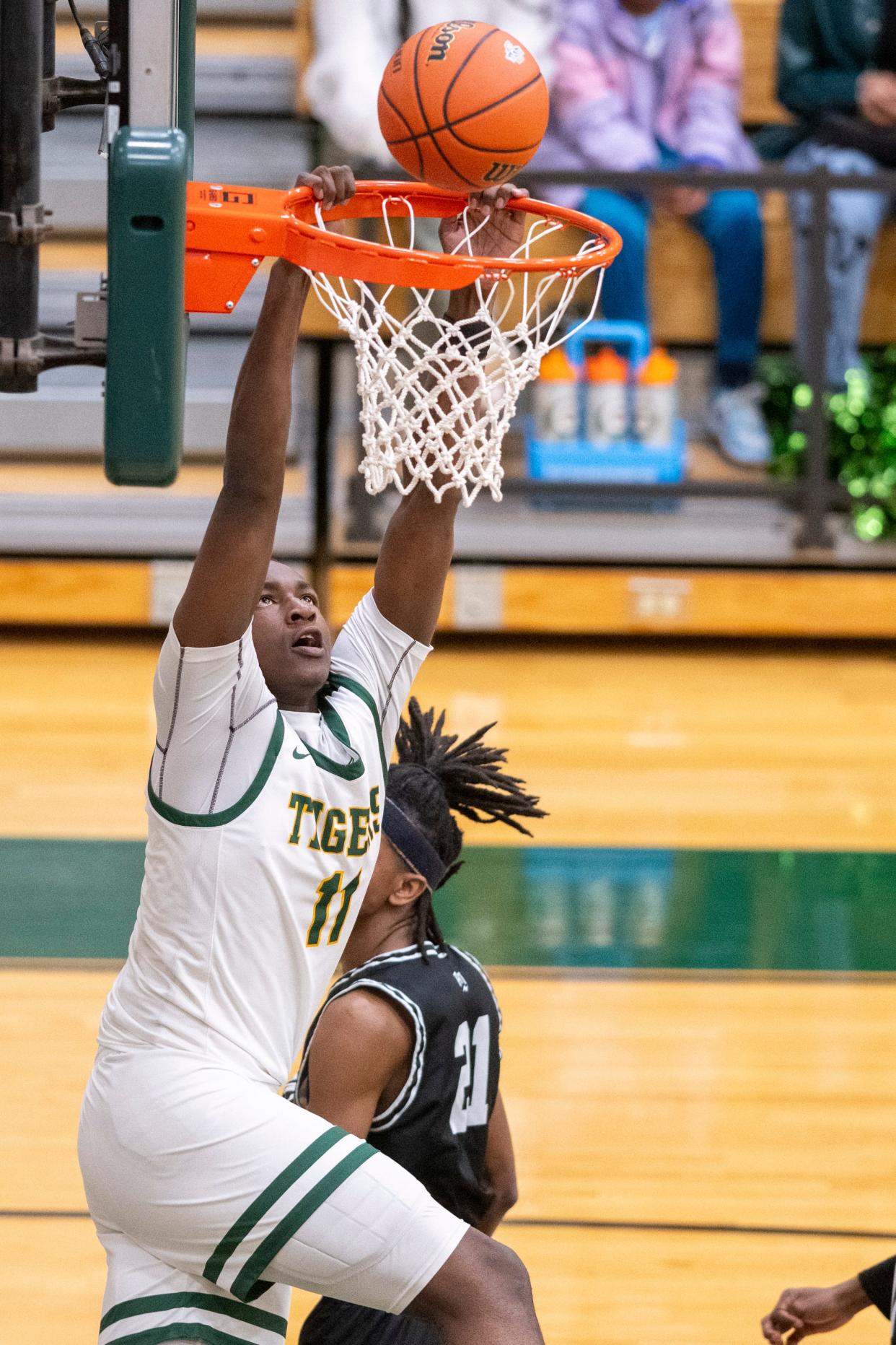 Indianapolis Crispus Attucks High School junior Dezmon Briscoe (11) attempts to score with a dunk during the second half of an IHSAA Class 4A Boys’ Sectional basketball game, Wednesday, Feb. 28, 2024, at Lawrence North High School. Crispus Attucks won.