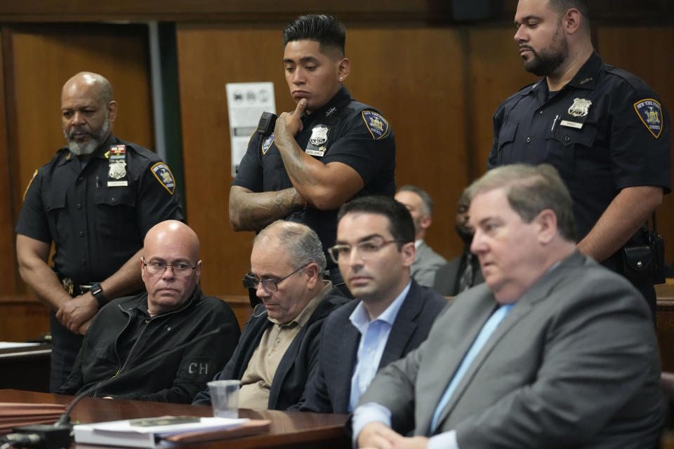 Former New York City's Buildings Commissioner Eric Ulrich, second from right seated, sits at in Supreme Court with his attorney and co defendants Anthony Livreri, left seated, and Joseph Livreri, second from left, Wednesday, Sept. 13, 2023, in New York. (AP Photo/Mary Altaffer)